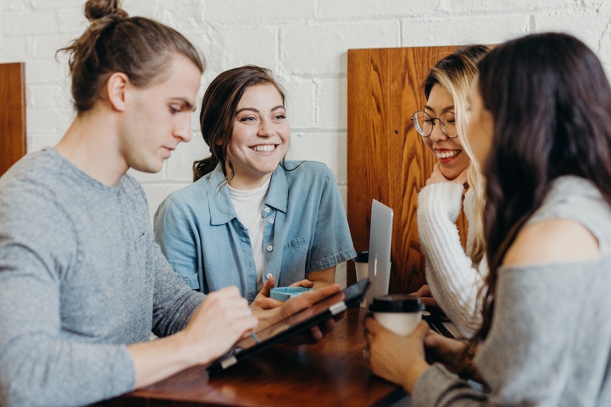 Four People Meet in a Modern Office to Discuss Business Salsify Time to Market Rules