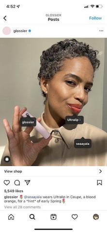 Glossier Instagram post of a model holding their lipstick product Ultralip 