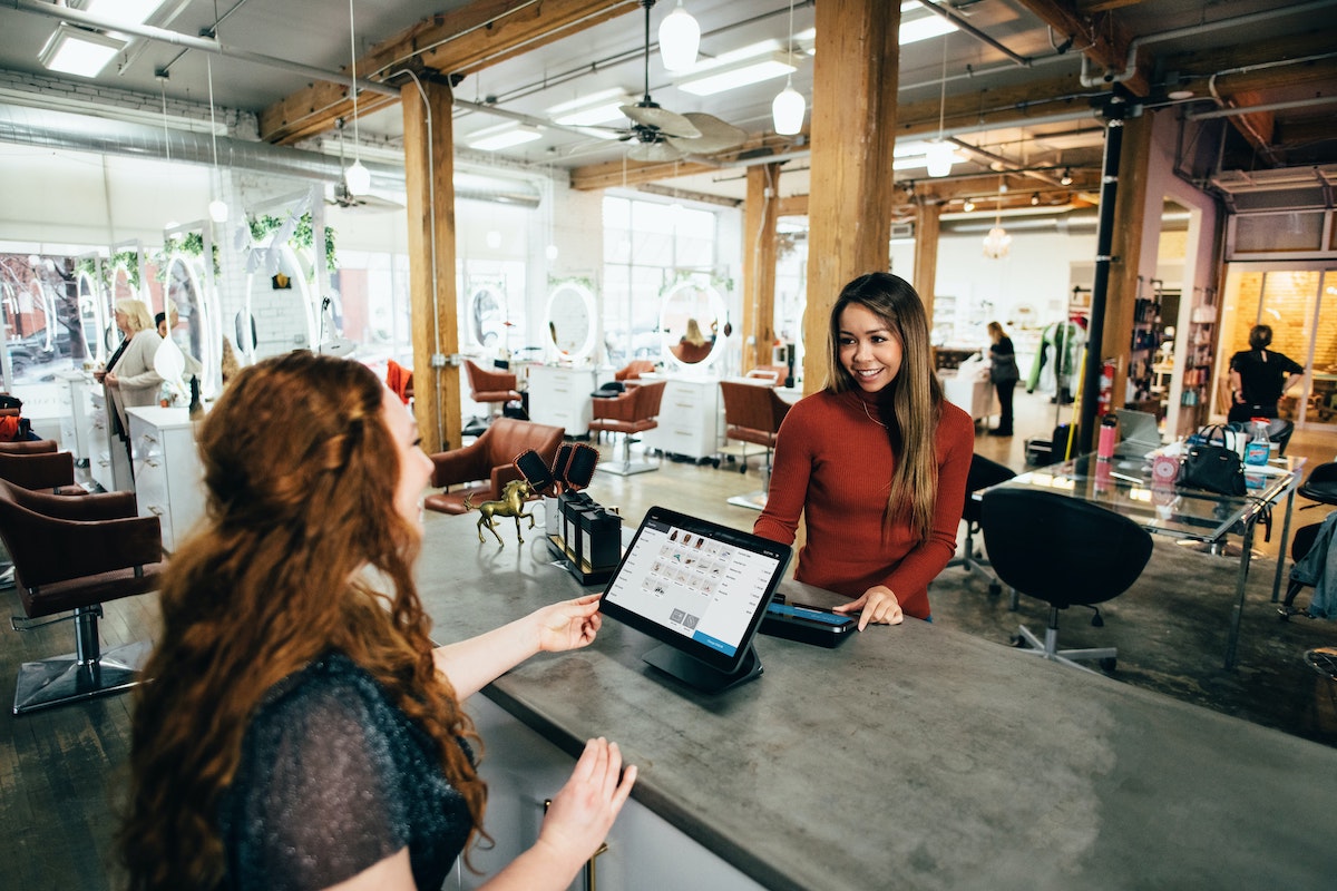 A Customer Pays at a Modern Salon Salsify Digital Shelf Management