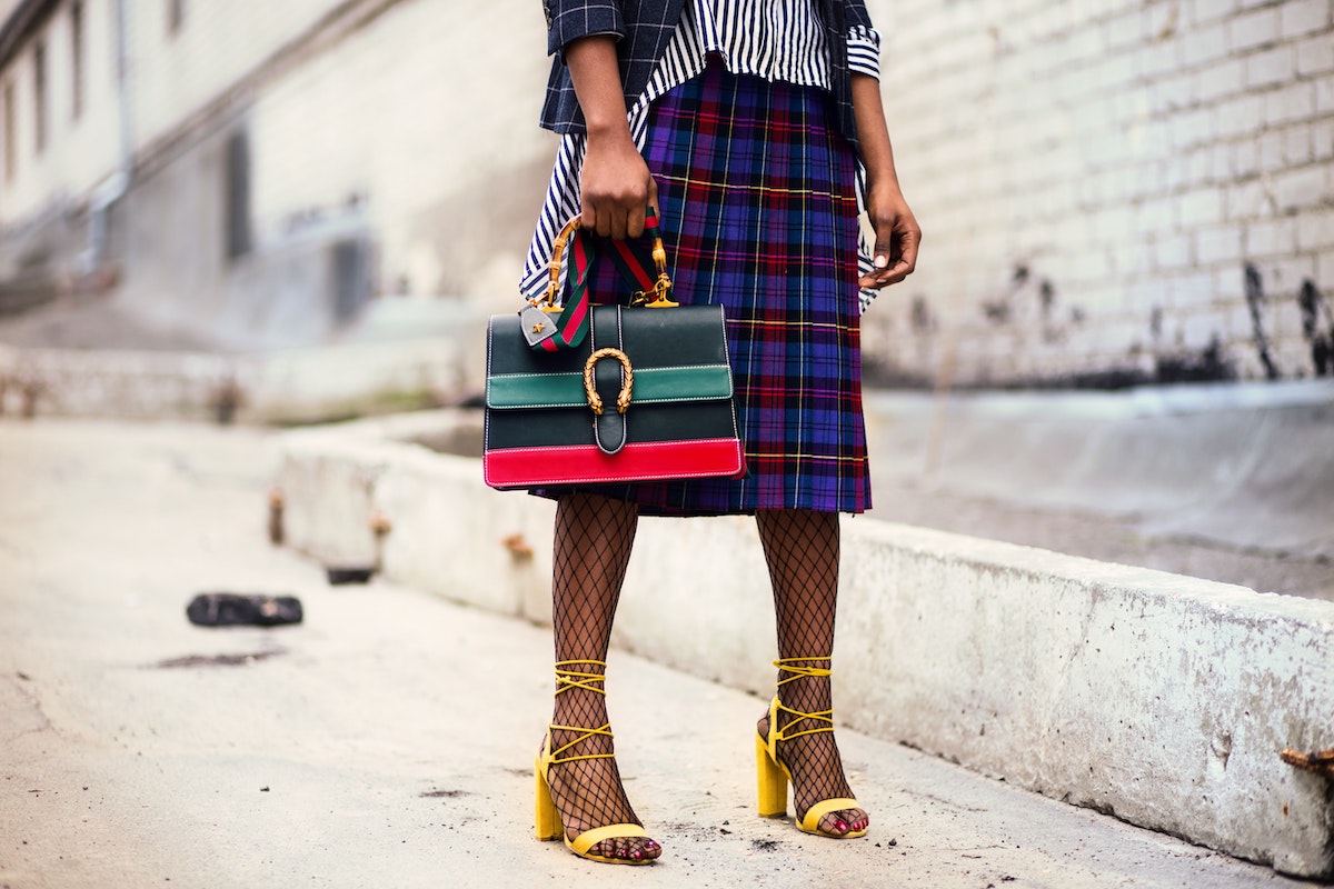 Woman Holds Green and Red Leather Bag Salsify D2C Apparel Brands